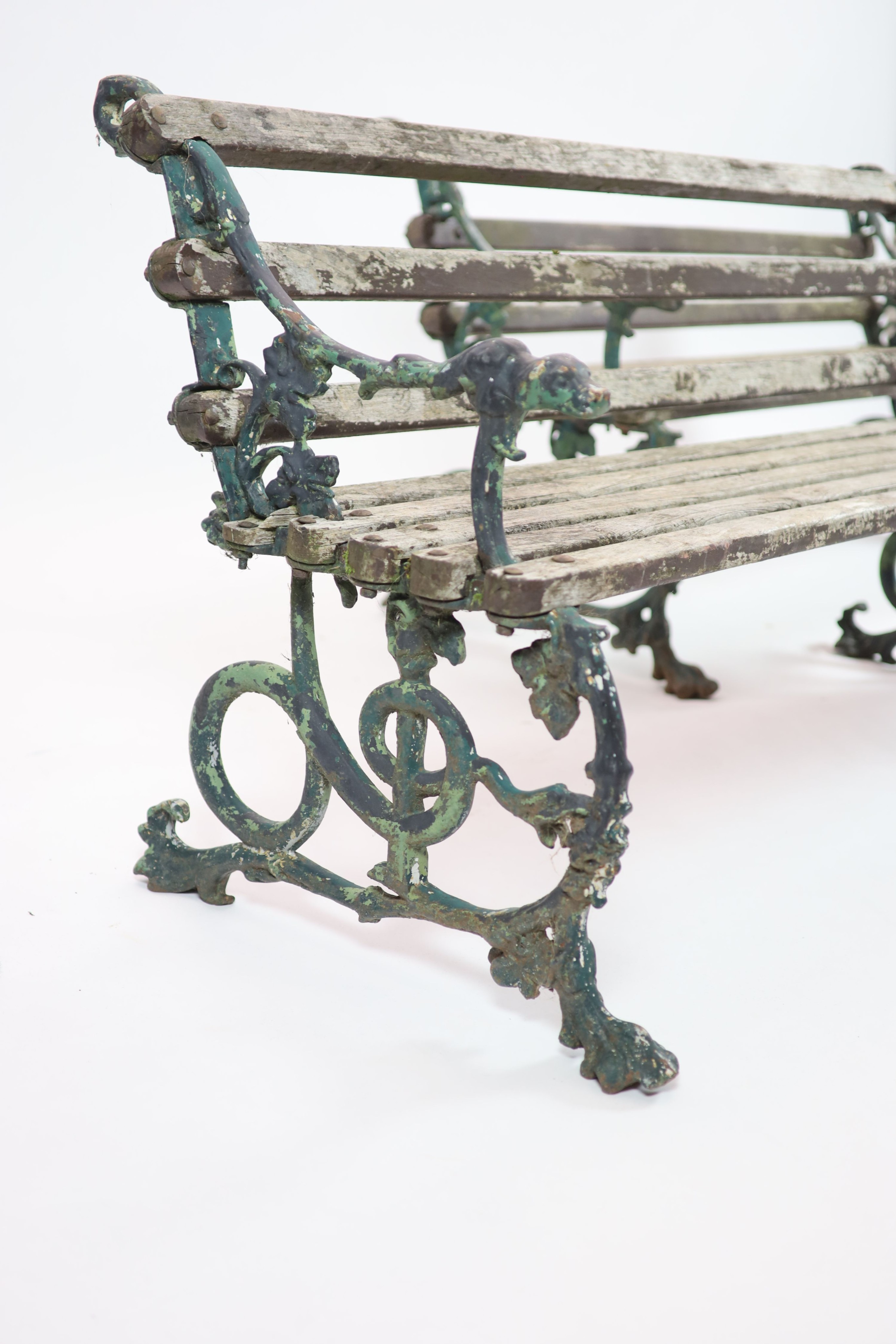 A pair of Victorian Coalbrookdale cast iron 'Grape and serpent' garden benches H 76cm. W 160cm. D 64cm.